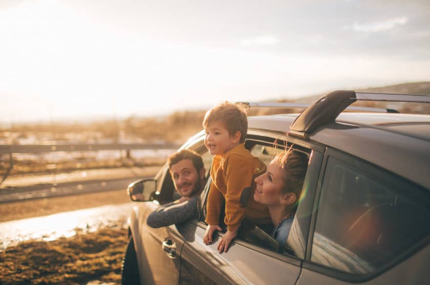 Family in car at beach