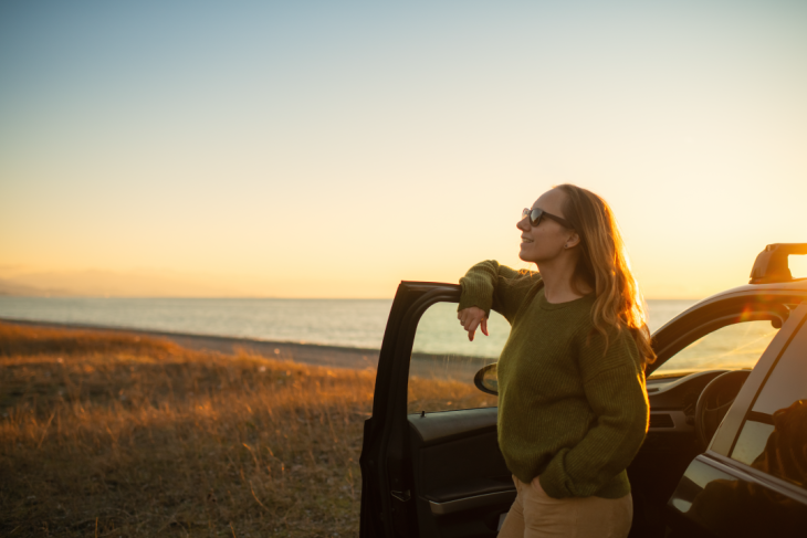 Woman standing next to vehicle