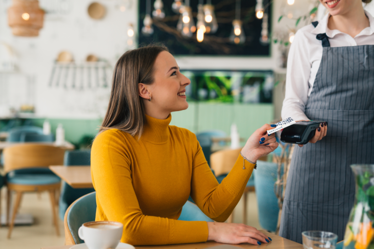 Woman paying with Reliant card