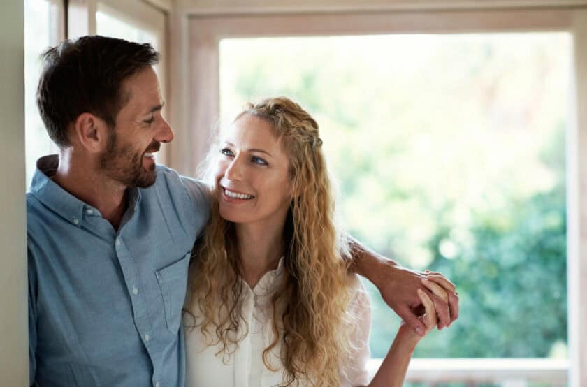 Couple standing in home