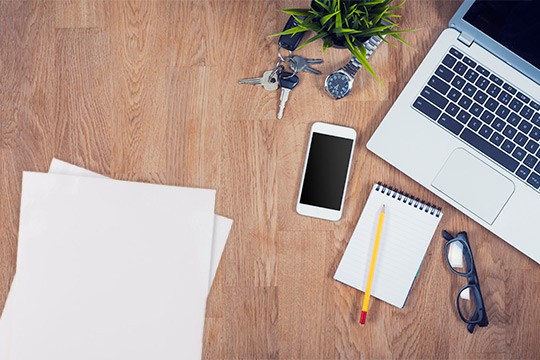 Desk with phone laptop documents
