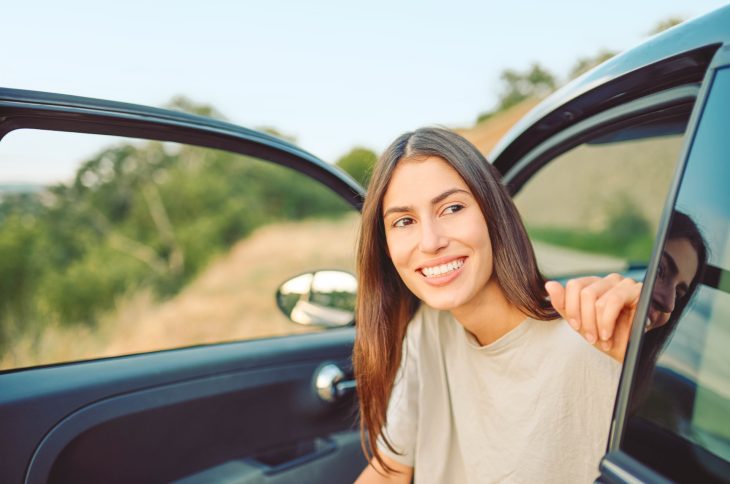 Woman getting out of car