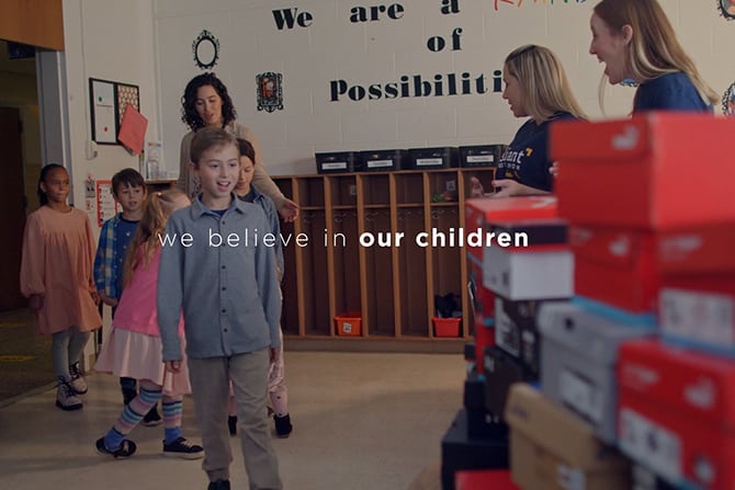 Feet Forward video thumbnail. Students walking into classroom.