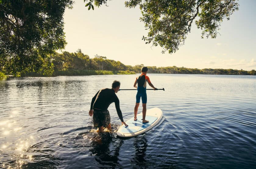Dad and son paddle boarding