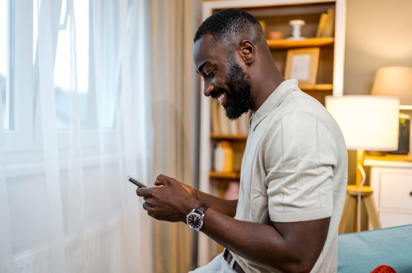 Man looking at phone and smiling