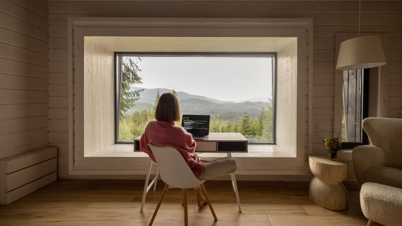 Girl looking out window on laptop