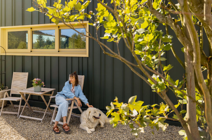 Woman sitting outside home
