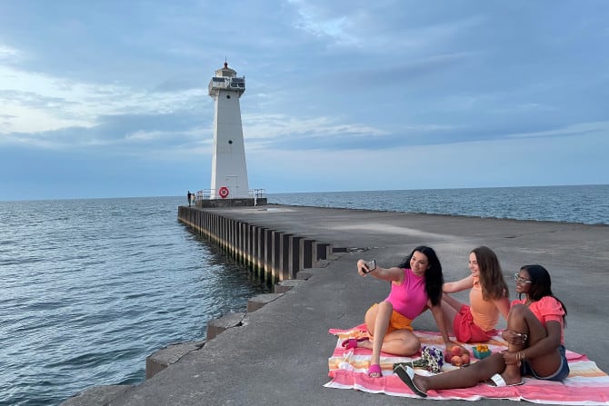 Girls on beach taking selfie