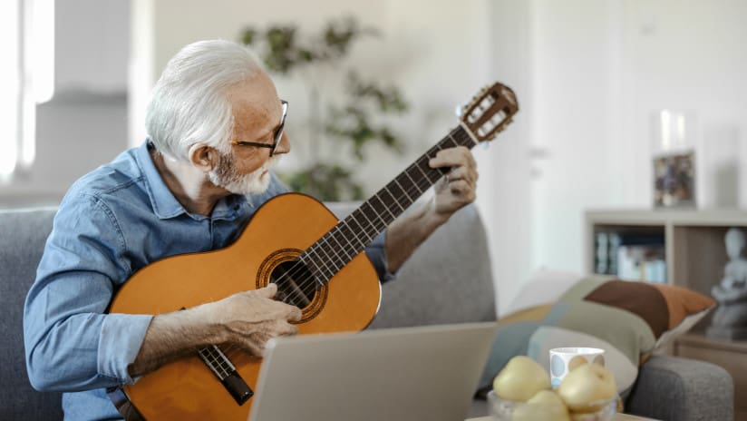 Older man playing guitar