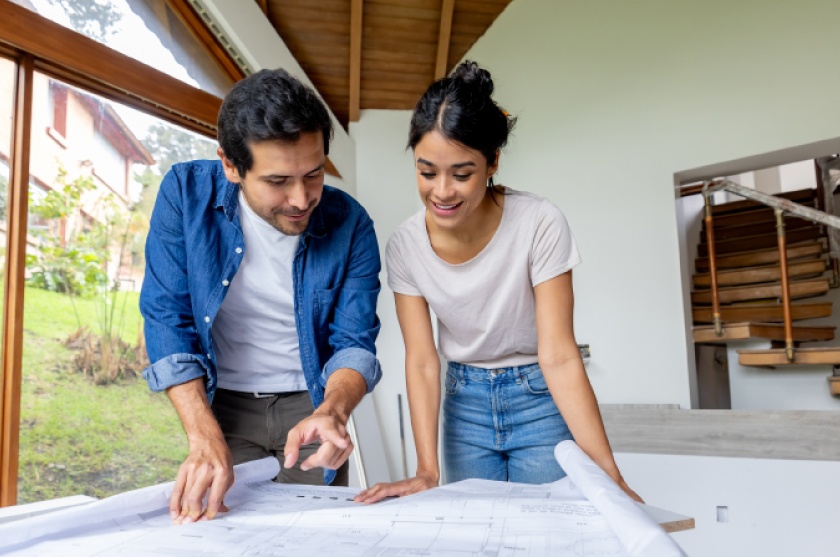 Couple looking at blueprints