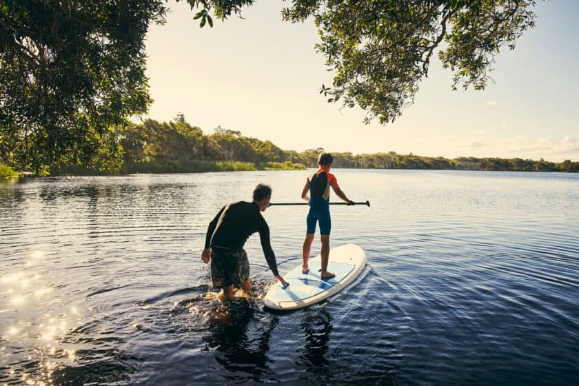 Dad and son on paddle board