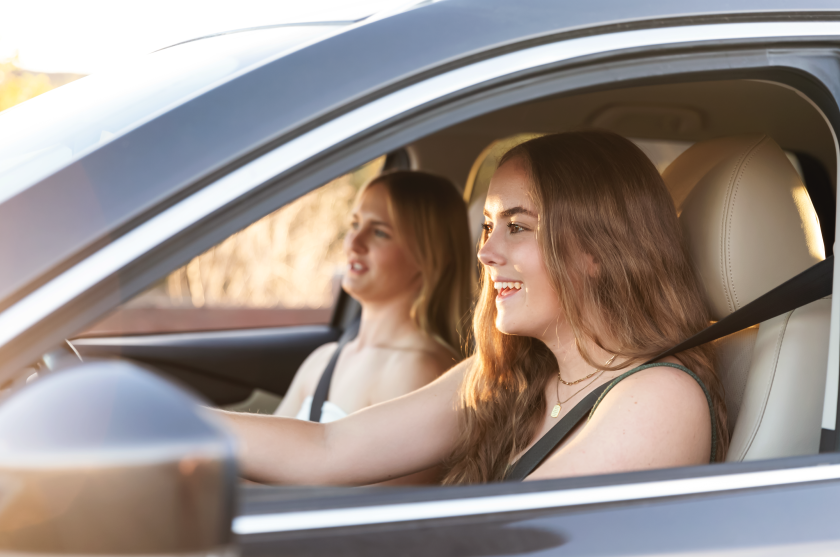 2 young women driving in car