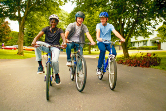 Teen boys biking down street